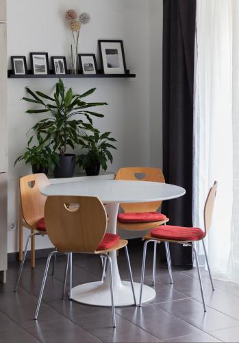a dining room with a white table and chairs at Dobó Apartman in Szeged