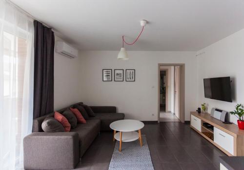 a living room with a couch and a table at Dobó Apartman in Szeged