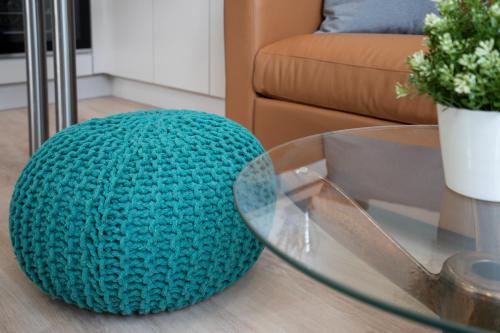 a blue ball sitting on a glass table in a living room at Ostseecamp Ferienhaus "StrandPerle" in Scharbeutz
