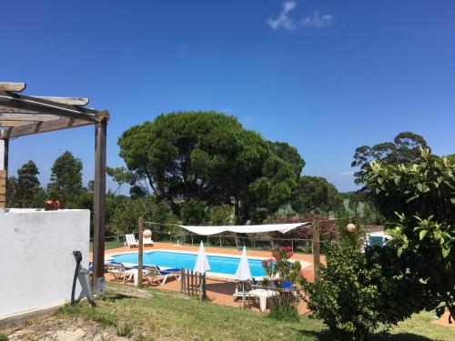 a view of the pool from the garden at Villa Monte dos Pinheiros in Grândola