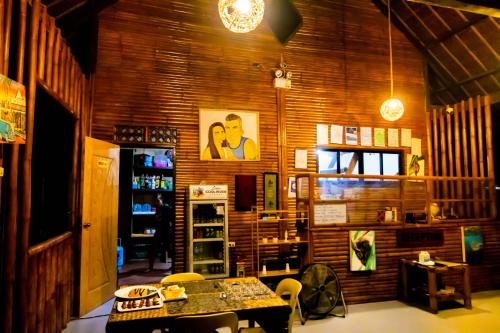 a room with a table and chairs in it at Loboc Cool River Resort in Loboc