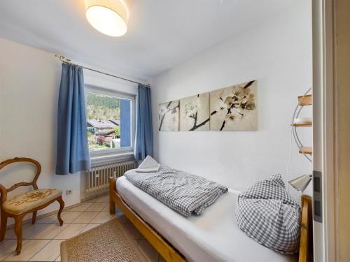 a bedroom with a bed and a window at FeWo Wankblick in Garmisch-Partenkirchen