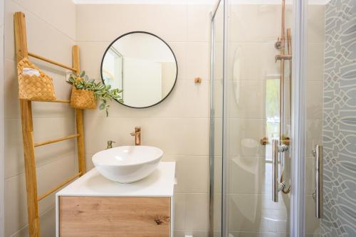 a bathroom with a sink and a mirror at Mila and Jurija Formenti 2 apartments in heart of nautic marina, with heated swimming pool, bikes, Sup, kajak in Skradin
