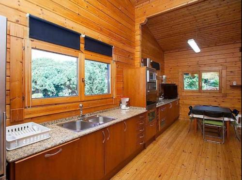 a kitchen with a sink and a window in a cabin at Nordica in Mataró