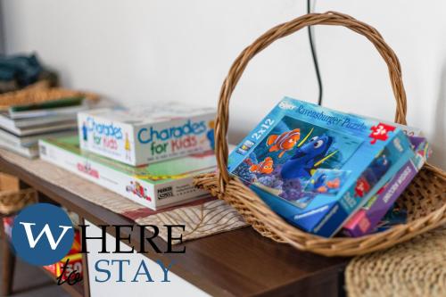 a basket of books sitting on top of a table at Elegant 4bed House-FREE parking in Barrow in Furness