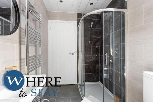 a bathroom with a shower with the words where to stay at Elegant 4bed House-FREE parking in Barrow in Furness