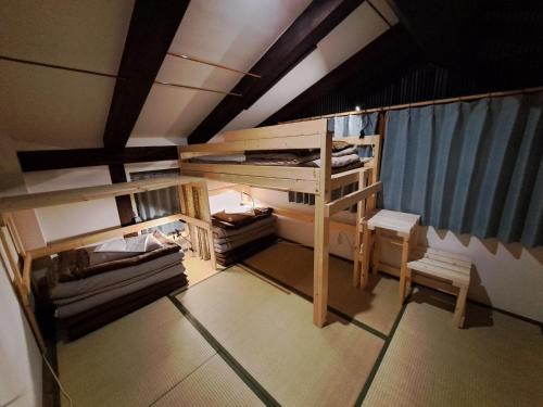a small room with a bunk bed and a table at Tototo Morioka in Morioka