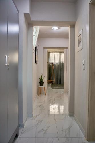 a hallway with marble flooring in a home at Petritis Villas B in Iraklitsa