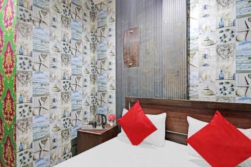 a bedroom with a bed with red pillows at OYO Hotel Dream Town 2 in New Delhi