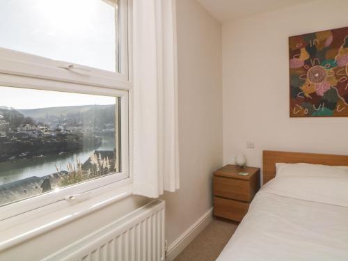 a bedroom with a window with a view at Estuary View in Plymouth