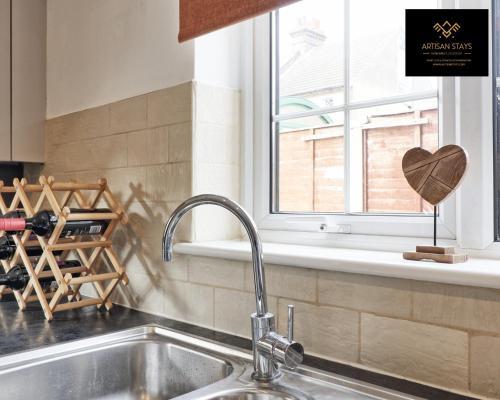 a kitchen counter with a sink and a window at Vintage Vibes By Artisan Stays in Southend-On-Sea I Contractors I Pvt Parking I Sleeps 5 in Southend-on-Sea