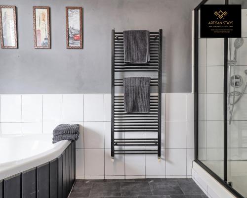 a bathroom with a towel rack and a bath tub at Vintage Vibes By Artisan Stays in Southend-On-Sea I Free Parking I Contractors & Families I Sleeps 5 in Southend-on-Sea