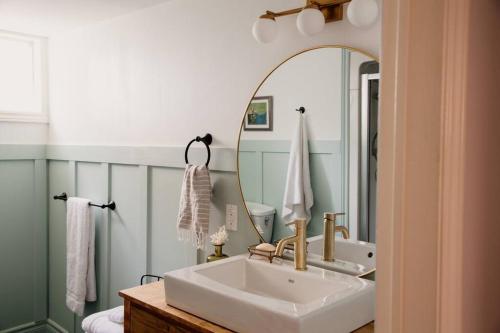 a bathroom with a sink and a mirror at The Dainty Petunia in Picton