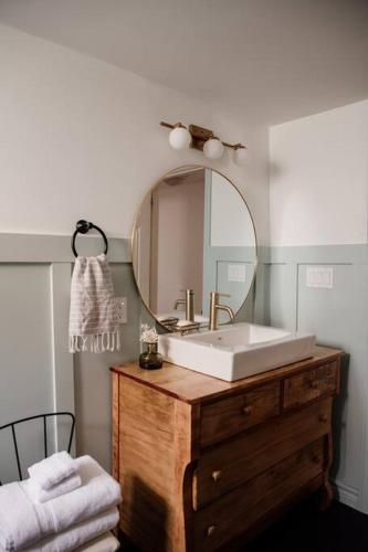 a bathroom with a sink and a mirror at The Dainty Petunia in Picton
