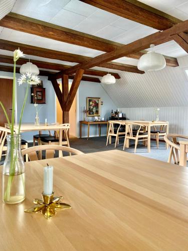 a large room with a table with chairs and a dining room at Rønhave in Sønderborg