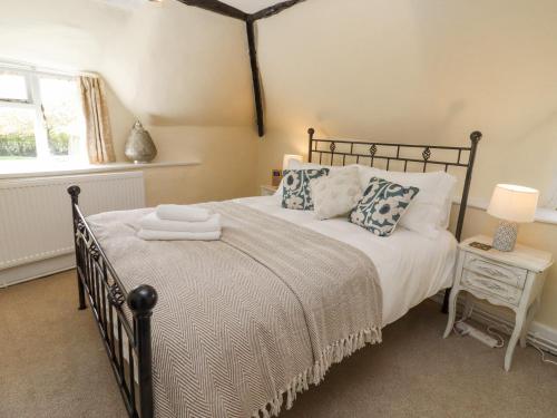 a bedroom with a large bed and a window at 5 Packhorse in Swindon