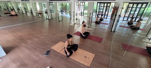 a group of women sitting on the floor in a gym at Centerpoint Hotel & Plaza in Thongsala