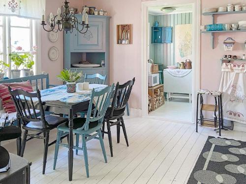 a dining room with a table and chairs at 6 person holiday home in ULLARED in Ullared