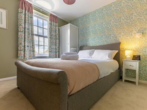 a bedroom with a large bed and a window at Pass the Keys The William Morris Lodge in the centre of Ludlow in Ludlow