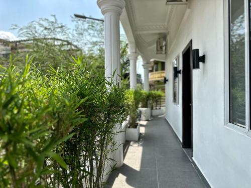 a porch with potted plants on the side of a building at Sun Chakra Boutique Hotel - 50m to Museum & Royal Palace & Walking street in Phnom Penh