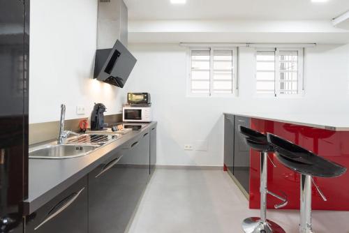 a kitchen with a sink and a red counter top at Incredible luxury location Banús beach for families in Marbella