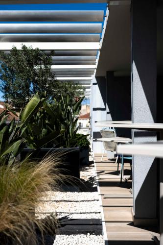 a patio with a table and chairs and plants at OKKO Hotels Toulon Centre in Toulon