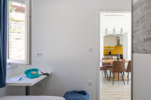 a kitchen and dining room with white walls at Seaview Vela Luka in Vela Luka