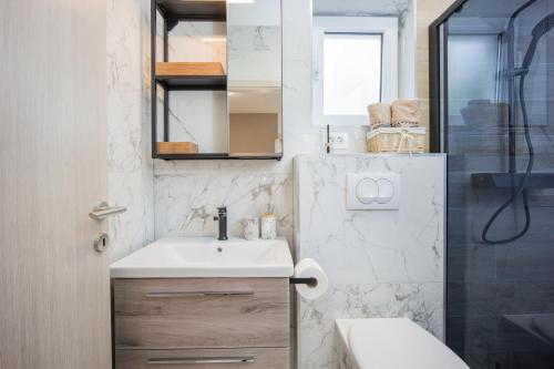 a small bathroom with a sink and a shower at Beautiful Holiday Home "Villa Relax Oasis" in Trogir