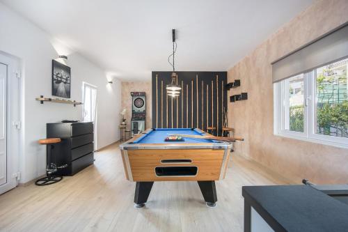 a ping pong table in the middle of a room at Beautiful Holiday Home "Villa Relax Oasis" in Trogir