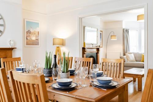 a dining room with a wooden table and chairs at Barnacle Nook - Norfolk Cottage Agency in Sheringham