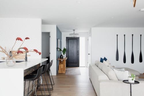 a living room with a white couch and a table at Wellers Landing - Prince Edward County Lakehouse in Carrying Place