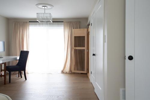 a living room with a table and a window at Wellers Landing - Prince Edward County Lakehouse in Carrying Place