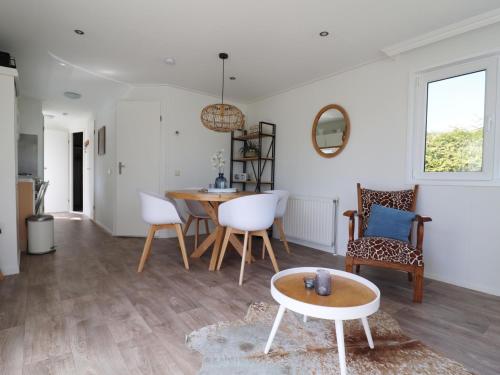a living room with a table and chairs at Cottage in Grou with Water Sports Access in Grou