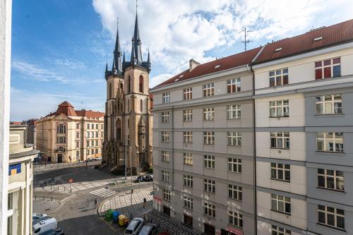 a building with a clock tower and a church at Vltava Apartments Prague 7 in Prague