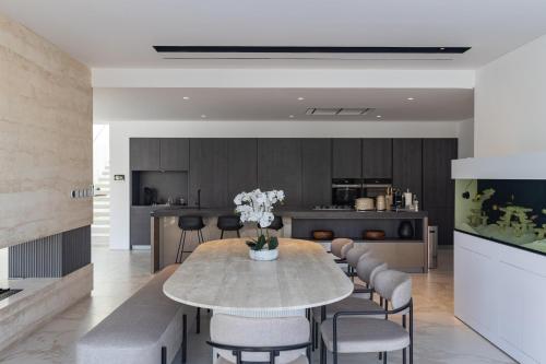 a kitchen and dining room with a table and chairs at Palm Jumeirah Paradise - 5BR Villa - Infinity Pool in Dubai