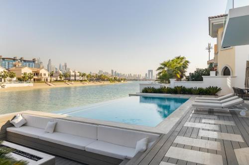 a view of a swimming pool in a building at Palm Jumeirah Paradise - 5BR Villa - Infinity Pool in Dubai