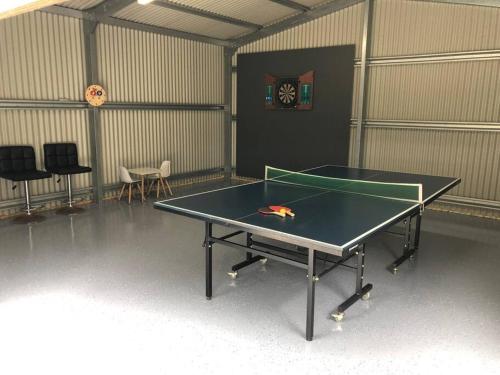 a ping pong table in a room with a table at Bronte Lodge, Wine Country Stay Hunter Valley with Games Room, Close to Town in Greta Main