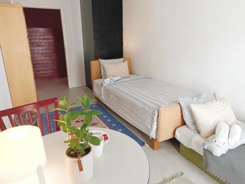 a bedroom with a bed and a table and a couch at Lounge-Style-Hostel in Sankt Veit an der Glan