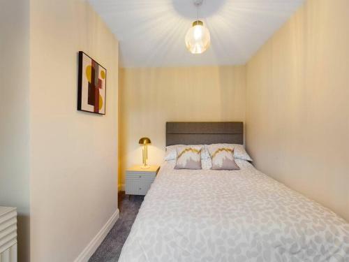 a bedroom with a large bed with a white bedspread at It's Broadway Baby! Great house close to City Centre in Belfast