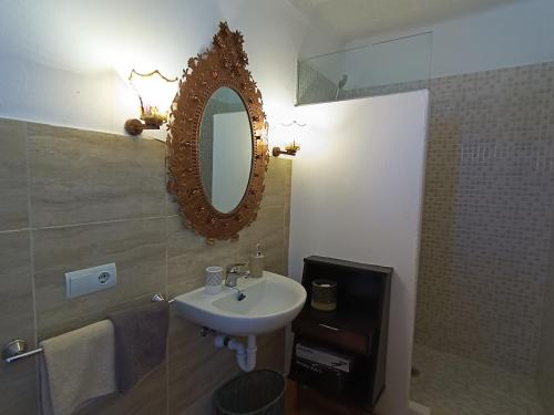 a bathroom with a sink and a mirror on the wall at wonderful sunsets views from terraces Last minute in Cala Vadella