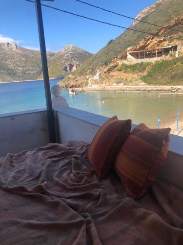 a bed with two pillows sitting on top of a boat at LITHOS Porto Kagio in Pórto Káyio