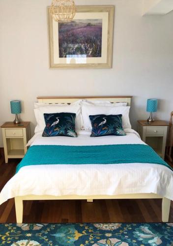 a bedroom with a large bed with two night stands at The Tower, Moray Firth Holiday Home in Kinloss