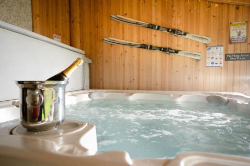 a bottle of champagne in a hot tub at Bracken House in Aviemore