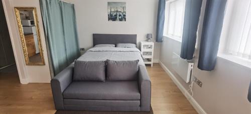 a bedroom with a bed and a chair in it at Beautifully designed private studio in Telford near M54 J4 in Telford
