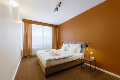 a bedroom with a large bed and a window at Bliss Residence & Spa in Budapest