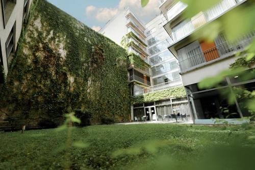 an ivy covered building with a green wall at Bliss Residence & Spa in Budapest