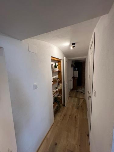 an empty hallway with white walls and wooden floors at TimHouse in Timişoara