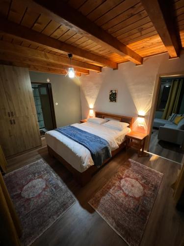 a bedroom with a large bed and two rugs at Villamill Apart & House in Ardeşen