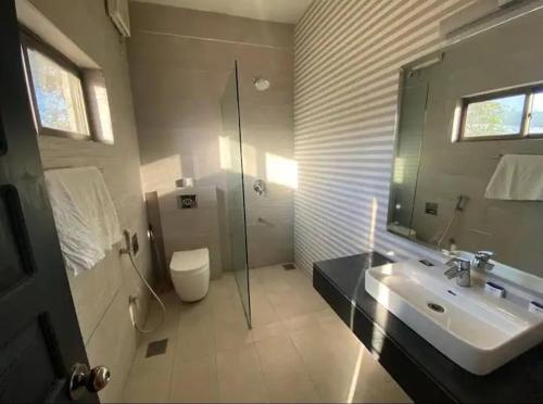 a bathroom with a sink and a shower and a toilet at Winter Hotel in Islamabad