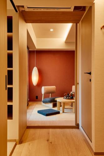 a hallway with a dining room and a table at LiveGRACE Hotel Azabu 麻布芝公園 in Tokyo